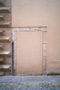 Old door walled up with cement and stones in a weathered old stone wall