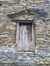 Old door of wooden planks in an ancient wall Royalty Free Stock Photo