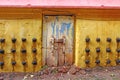 Old door and yellow wall of an ancient Hindu temple with oil lamps Royalty Free Stock Photo