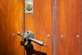 Old doorhandle on the brown door lighted by sun Royalty Free Stock Photo