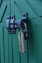 Old doors gates closed with black metall padlock with hasp