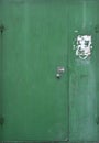 The old double-floor iron door is green and vintage-like.