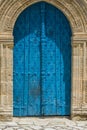 An old double-leaf door in the cathedral in the Cypriot village Lefkara. Arched entrance to the cathedral. the stone around the Royalty Free Stock Photo