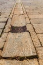 Old drain and stone covered street