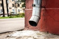 Old drain pipe on the brown brick wall. Downspout. Royalty Free Stock Photo