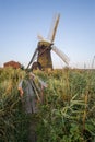 Old drainage windpump windmill in English countryside landscape Royalty Free Stock Photo