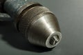 Old drill chuck on a gray background. Details of an old drill Royalty Free Stock Photo