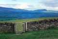 Old dry stone wall in welsh countryside, mountains in background Royalty Free Stock Photo