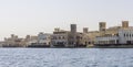 Old Dubai wind towers along the Dubai creek, as seen from an Abra water taxi Royalty Free Stock Photo