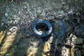 Old tire in the river Royalty Free Stock Photo