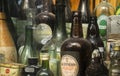 Old and dusty bottles in the outside display case of an Irish pub