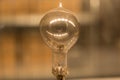 Old dusty light bulb glowing in the dark Royalty Free Stock Photo