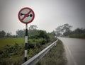 Old dusty no horn sign at the highway