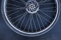 Old dusty single bicycle wheel on a dark background