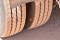 Old Dusty Truck Tire With punkture Repair Hole outside Royalty Free Stock Photo