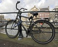 Old dutch bike chained against a bridge Royalty Free Stock Photo