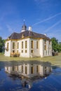 Old dutch mansion Fraeylemaborg with reflection in the water in