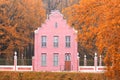Old Dutch pink brick house with vintage fence in autumn Royalty Free Stock Photo