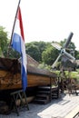 Old dutch scenery with flag and windmill
