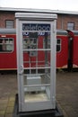 Old dutch telephone box as history on a platform at the railway museum in utrecht, the Netherlands.