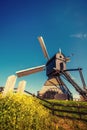 Old Dutch windmills spring from the canal in Rotterdam. Holland