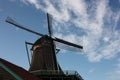 Old dutch wooden windmill in zaanse schans on the water of the river Zaan Royalty Free Stock Photo