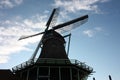 Old dutch wooden windmill in zaanse schans on the water of the river Zaan Royalty Free Stock Photo