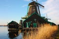 Old dutch wooden windmill in zaanse schans on the water of the river Zaan Royalty Free Stock Photo