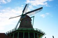 Old dutch wooden windmill in zaanse schans on the water of the river Zaan Royalty Free Stock Photo