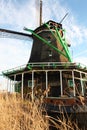 Old dutch wooden windmill in zaanse schans on the water of the river Zaan Royalty Free Stock Photo