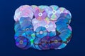 Many DVDs are stacked on blue cloth. Royalty Free Stock Photo