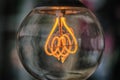 Old edison light bulb glowing in the dark Royalty Free Stock Photo