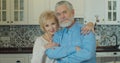 Old elderly adult family couple hugging bonding looking at camera, smiling healthy senior retired grandparents, close up