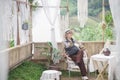 Old elderly senior woman resting relaxing sitting in wooden gazebo in garden park Royalty Free Stock Photo