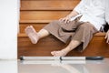 Old elderly lies unconscious on the floor of the staircase after slipping,tripping or losing balance while walking,moving with