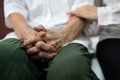 Old elderly patient hands clasped together because of excitement and nervousness,daughter holding touching her arm,care support Royalty Free Stock Photo