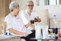 Old elderly people drinking soft drink,eat junk food,snacks on the table at home,asian senior women holding glass of beverages