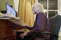 Old elderly senior person learning computer and online internet skills beware money fraud scam spam Royalty Free Stock Photo