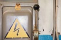An old electric high-voltage switch with a painted danger sign. Royalty Free Stock Photo