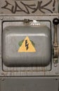 Old electric high-voltage switch with a painted danger sign. Abstract danger background. Royalty Free Stock Photo