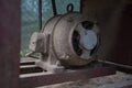 Old electric motor powering a table saw bench saw. Vintage industrial equipment concept. Rusty and dirty electric engine power