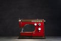 Old electric sewing machine on dark background, home workshop Royalty Free Stock Photo