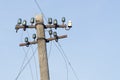 Old electric wooden pole with glass and ceramic insulators.