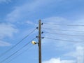 Old electricity street lamp and wires on wodeen post with background blue cloudy sky Royalty Free Stock Photo