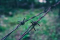 Old electrified fence with barbed wire. Terror jail concept, bar