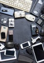 Old electronic devices on a dark background. The concept of recycling and disposal of electronic waste. Royalty Free Stock Photo