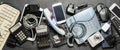 Old electronic devices on a dark background. The concept of recycling and disposal of electronic waste. Royalty Free Stock Photo