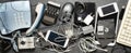 Old electronic devices on a dark background. The concept of recycling and disposal of electronic waste. Royalty Free Stock Photo