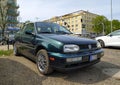 Old dark green Volkswagen Golf II convertible parked