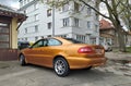 Old elegant veteran classic saffron pearl metallic coupe car Volvo C70 parked